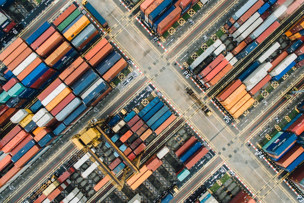 Aerial view of shipping containers, representing international trade